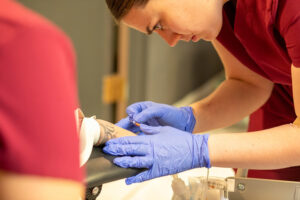 Phlebotomist student training at school